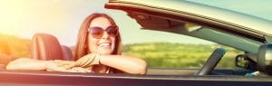 woman smiling in her car