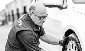 Darryl Burrows repairing a car
