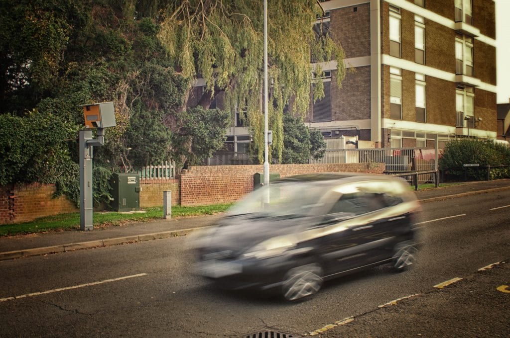 car driving down the street at a speed