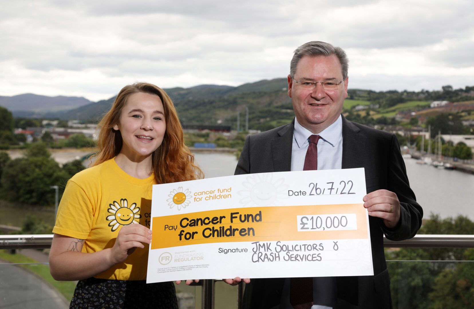 Jonathan presenting £10,000 cheque to Cancer Fund for Children