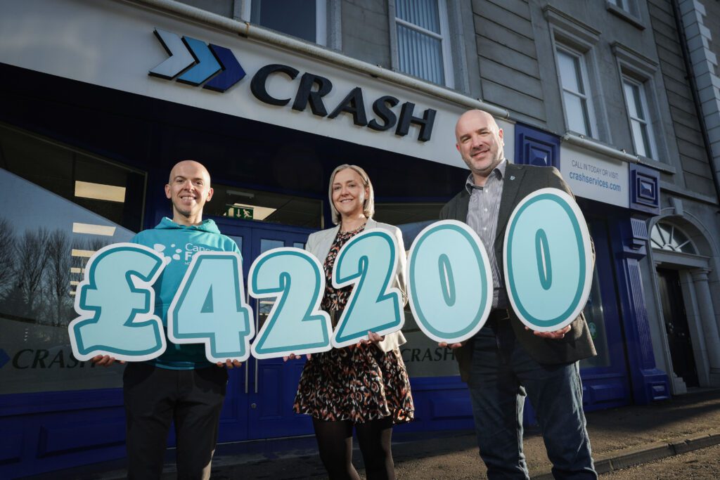 CRASH Services and JMK Solicitors staff presenting a cheque to Cancer Focus Northern Ireland